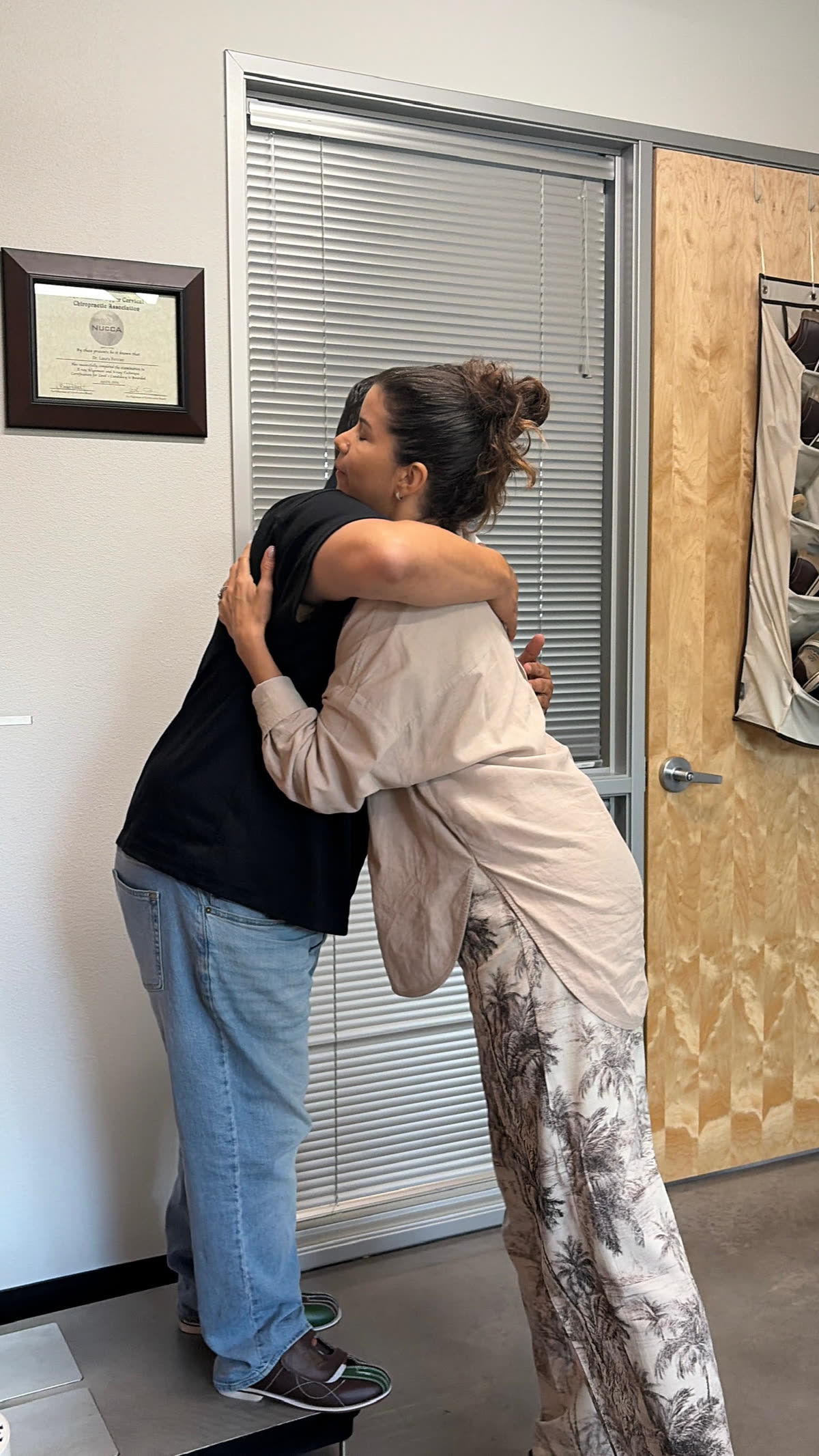 Dr. Laura hugging a patient after a visit