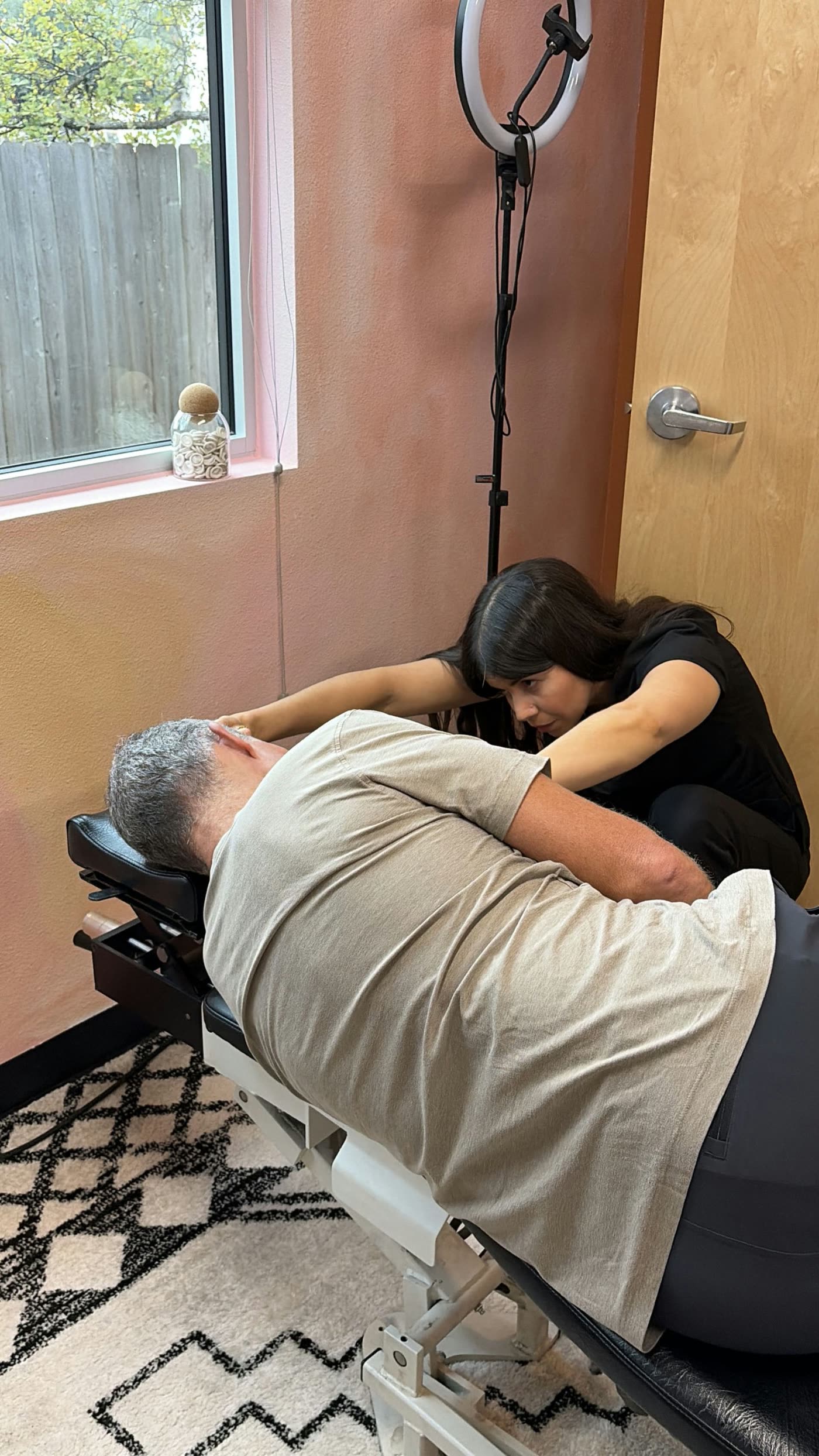 Dr. Laura making a gentle adjustment while a patient rests on his side