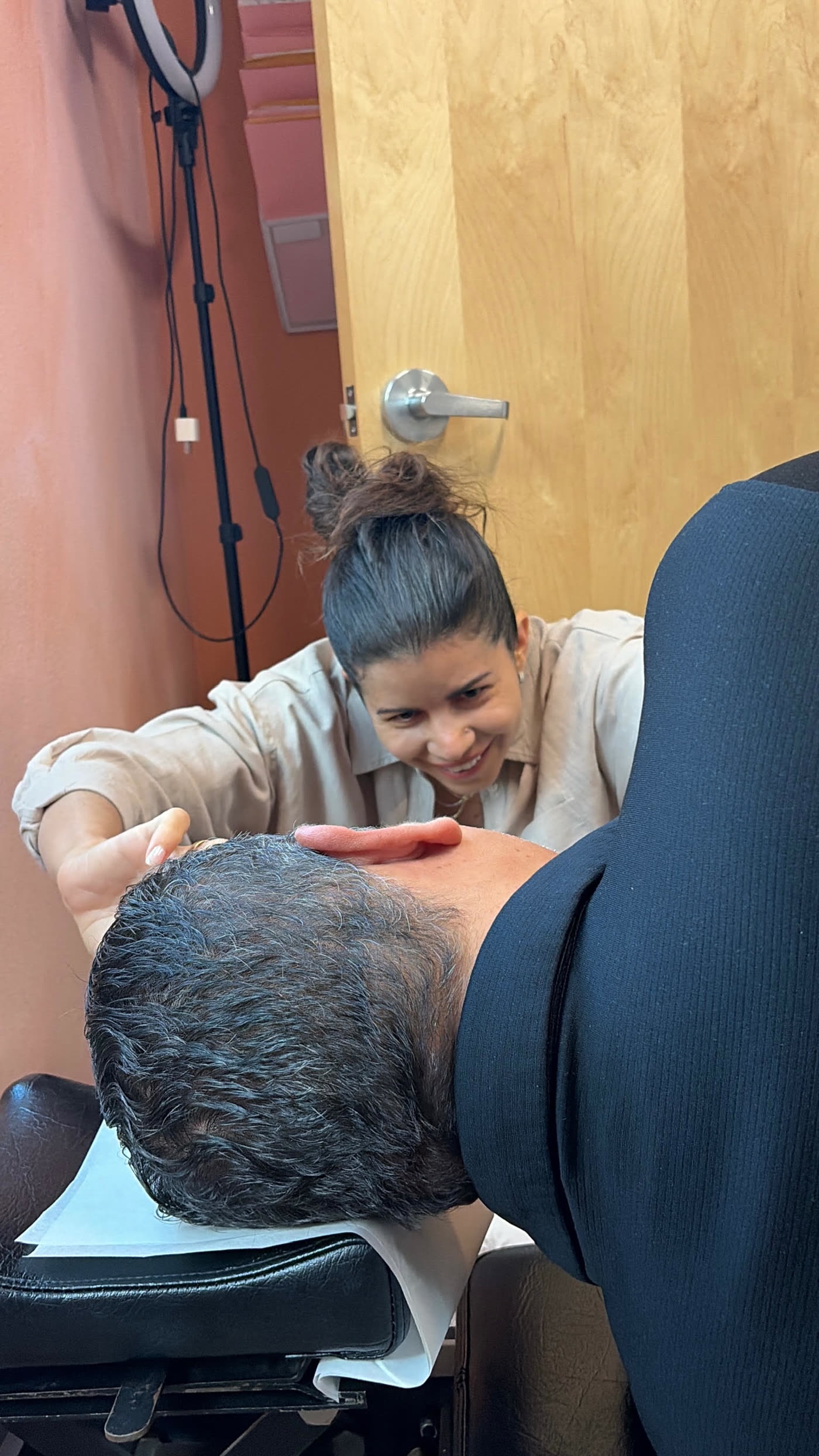 Dr. Laura smiling with a patient on the adjusting table