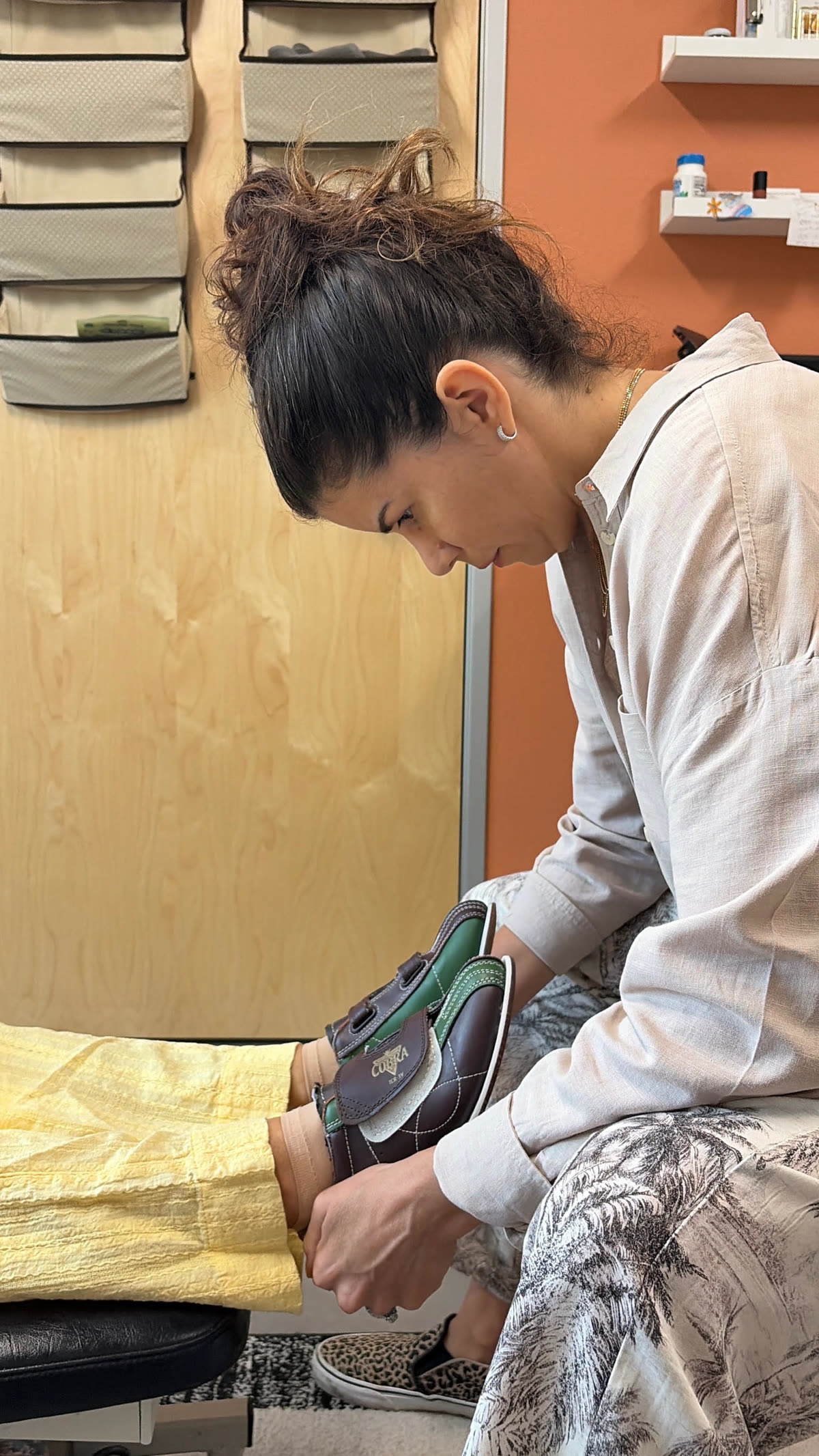 Dr. Laura comparing the length of a patient's legs at the heels