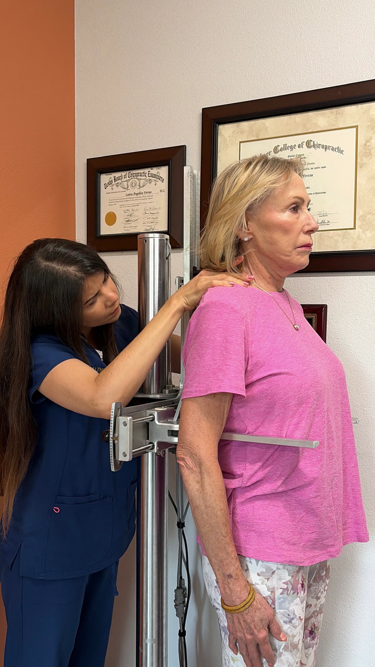Dr. Laura gently checking a patient's shoulder and posture alignment