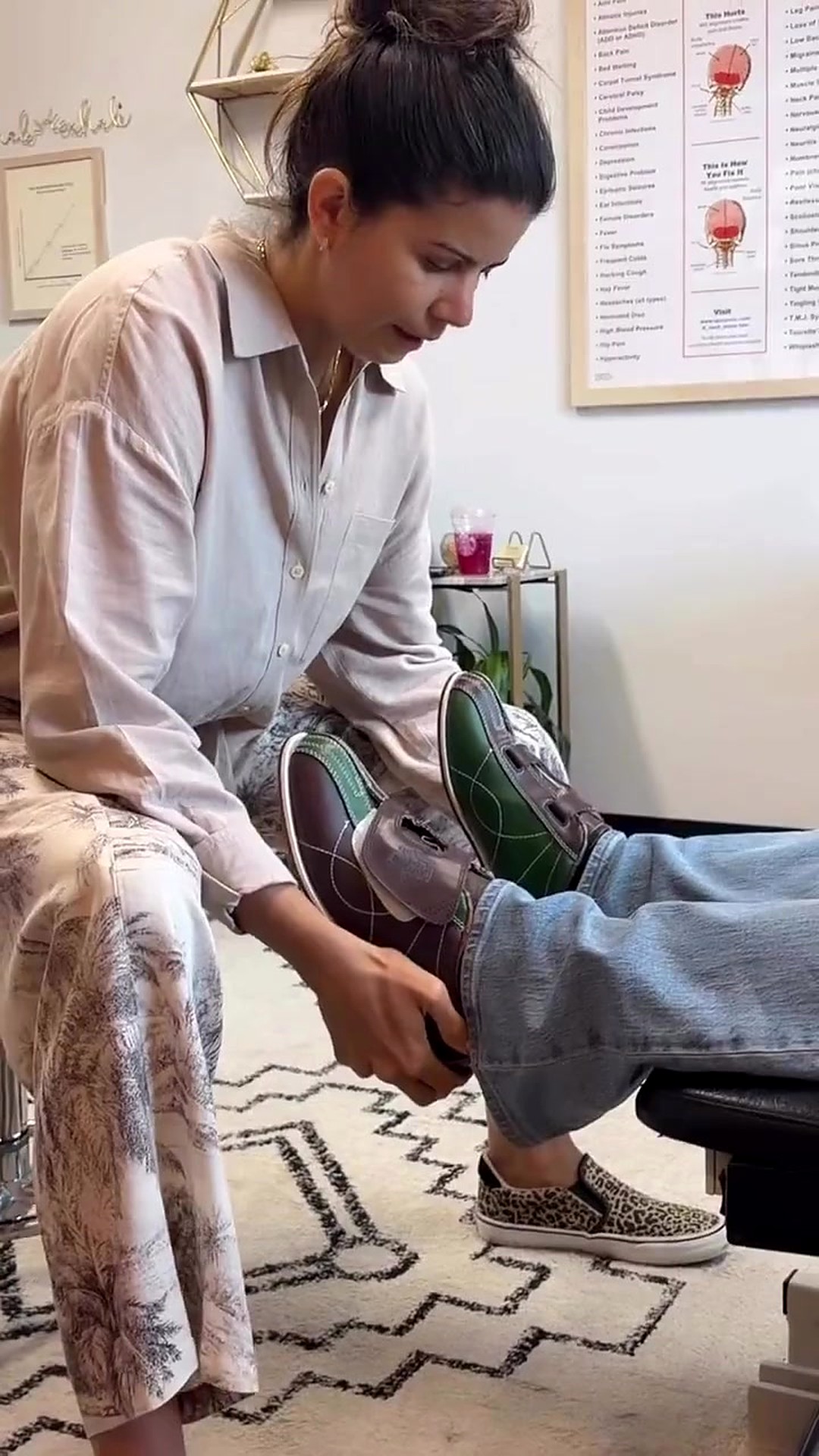 Dr. Laura checking a patient's leg length at the feet